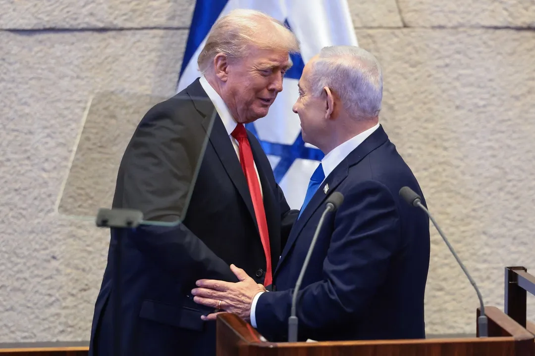 President Donald Trump talks with Israel's Prime Minister Benjamin Netanyahu at the Knesset, October 13, 2025 (AP).