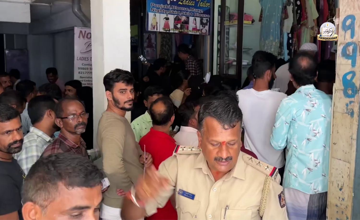 Local police and affected residents assembled outside the closed Global Enterprises shop on Car Street in Bhatkal, investigating the fraud case where shop owners fled with lakhs of rupees