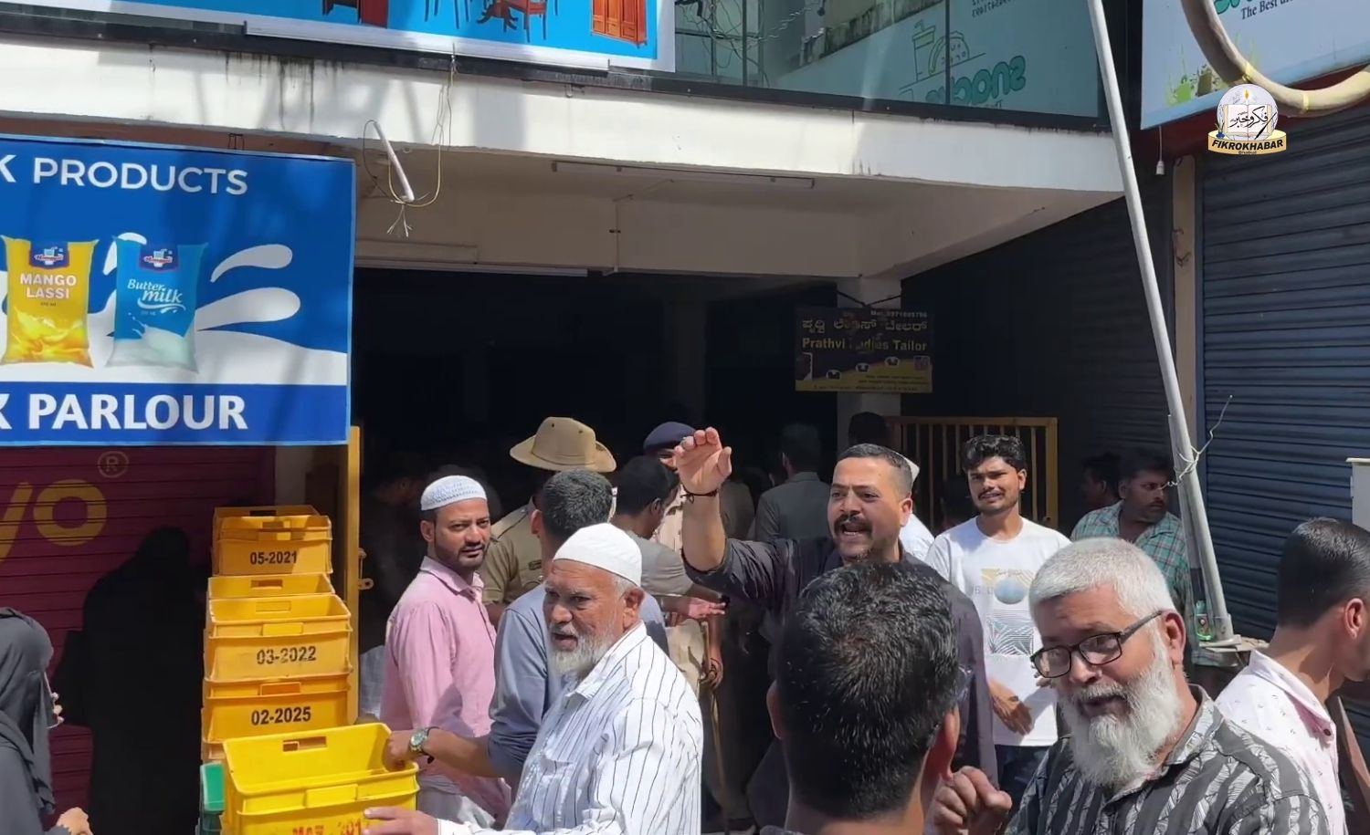 Crowd of people assembled outside the closed Global Enterprises shop on Car Street in Bhatkal, where shop owners allegedly fled with lakhs of rupees after collecting advance payments from customers